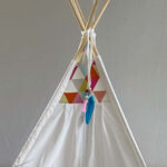 White teepee with colourful triangles details